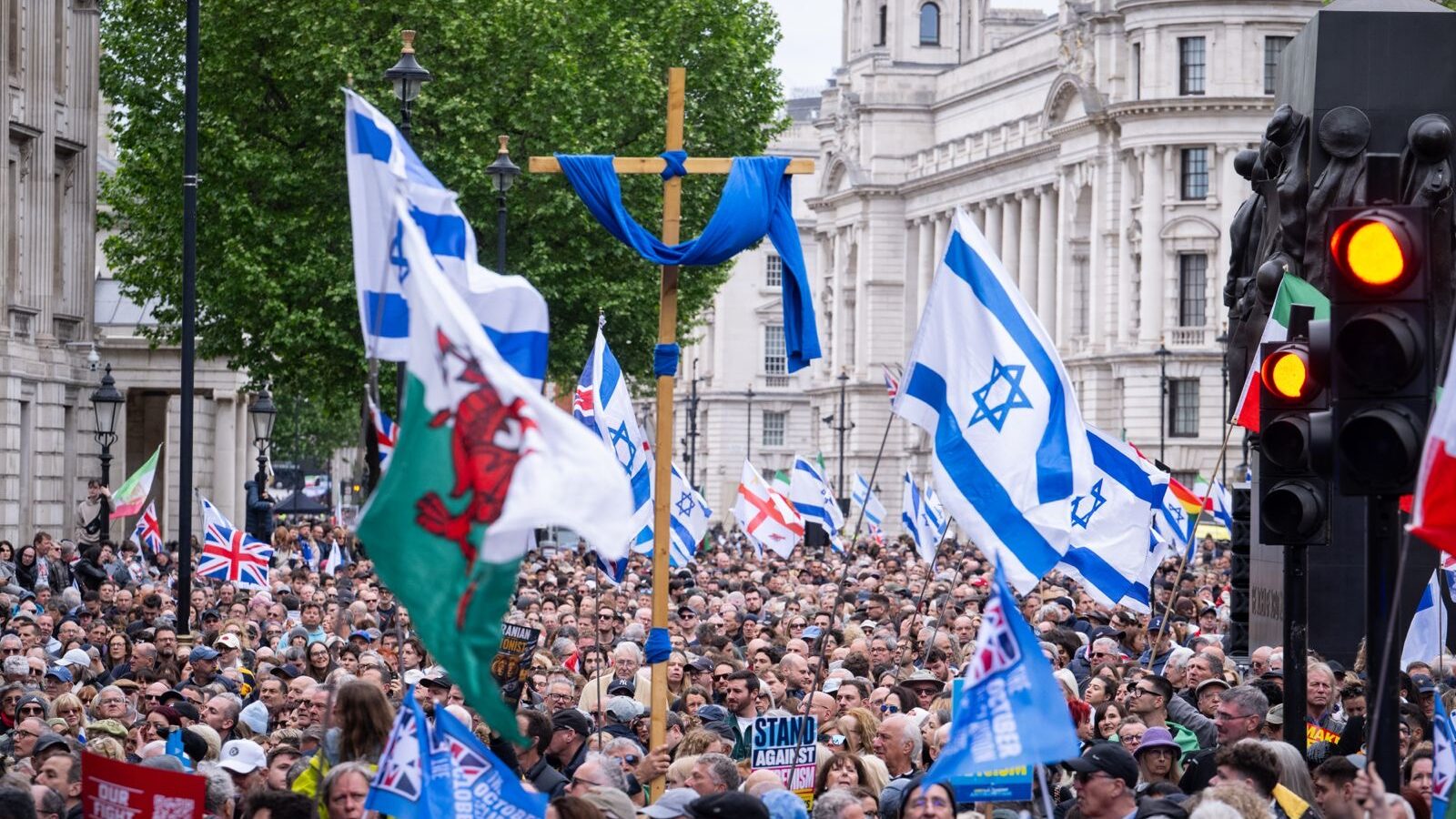 Whitehall filled with people holding Israeli flags and Union flags at the rally against antisemitism
